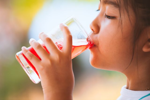 Child drinking red juice