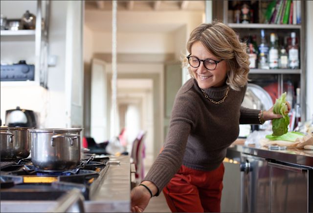 mature woman with eyeglasses cooking in kitchen