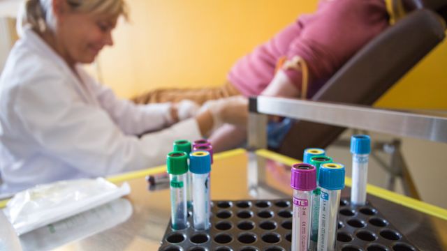 A healthcare provider draws blood for testing from a male patient in a healthcare office. Bloodwork is an important part of diagnosing and monitoring MDS.