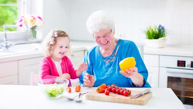 grandparent with child in the kitchen