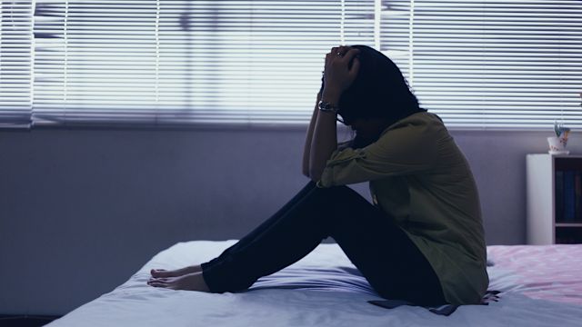 A woman with bipolar disorder sits alone in a bedroom. Untreated bipolar disorder can become more severe, disrupting relationships and many other aspects of a person's life.