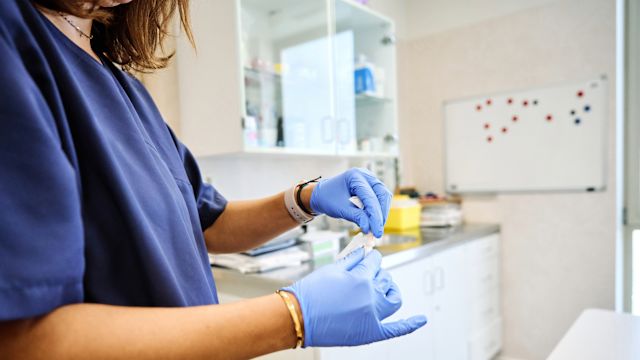 A healthcare provider prepares an injection of subcutaneous immunotherapy in a healthcare office.