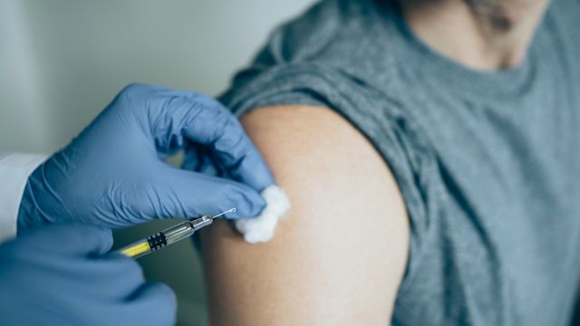 A young man receives a subcutaneous injection of a long-acting medication for opioid use disorder (MOUD) from his healthcare provider.