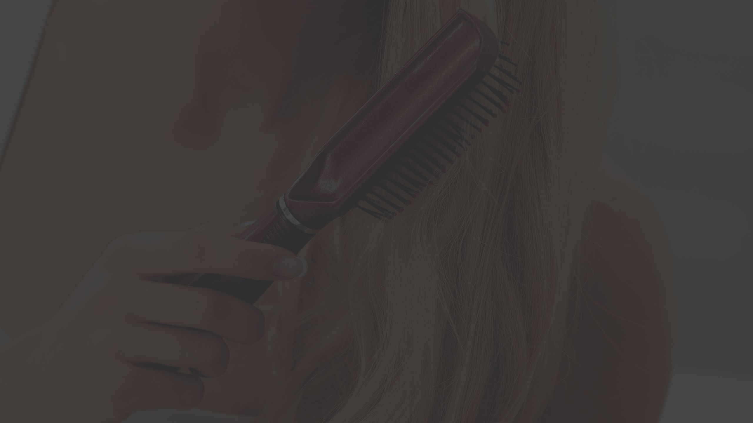 woman brushing her blonde hair