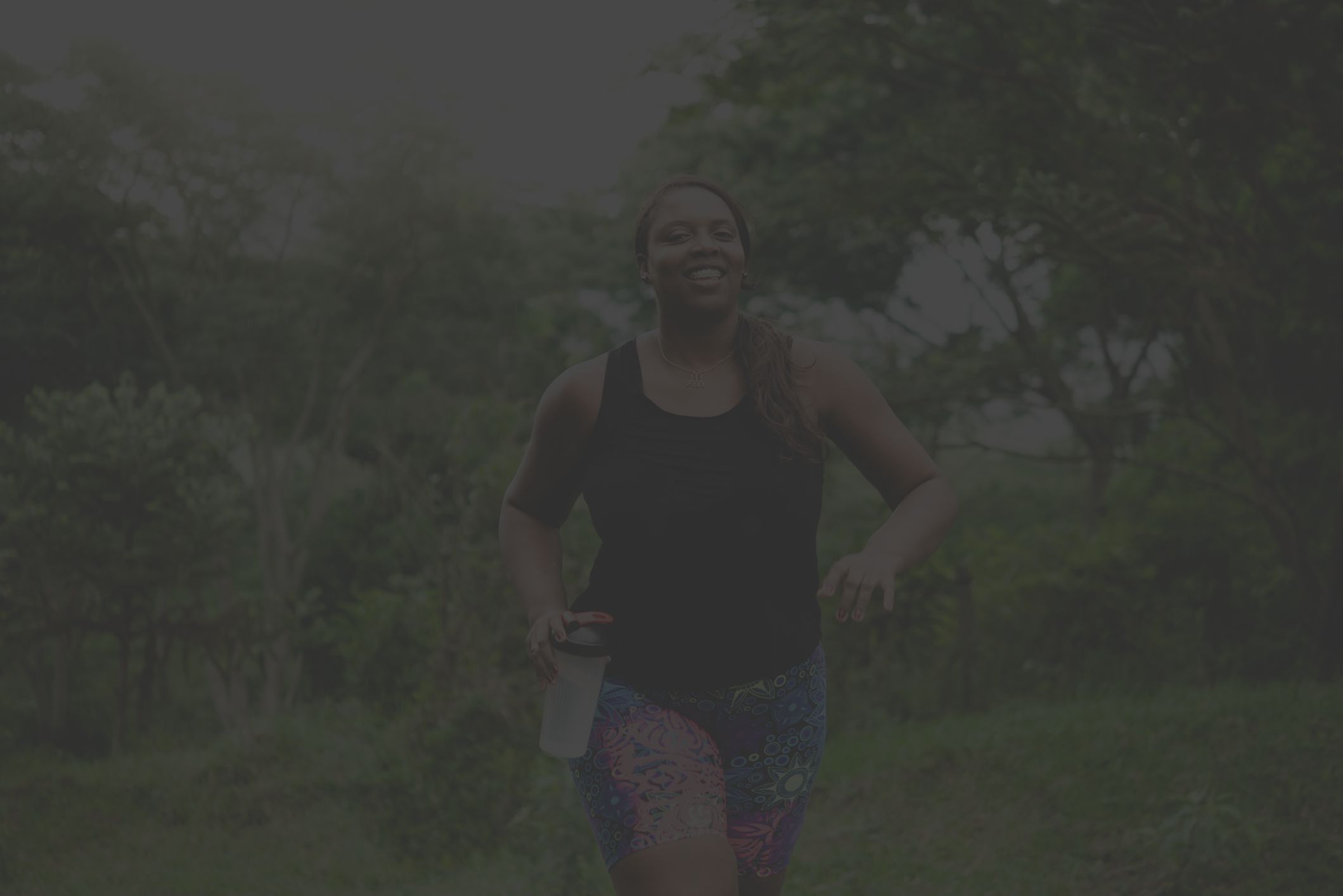 Woman in bright colorful shorts running outside 