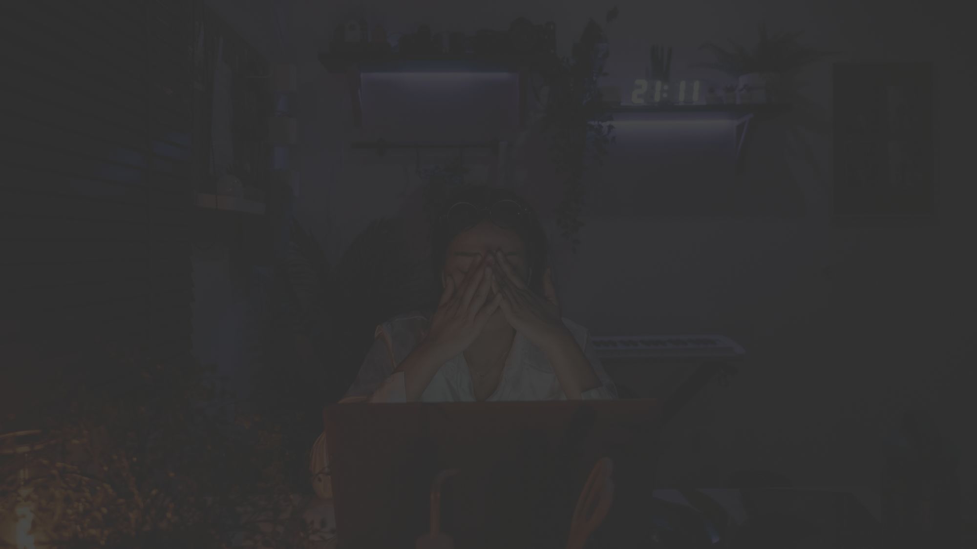 woman in front of laptop in dark room