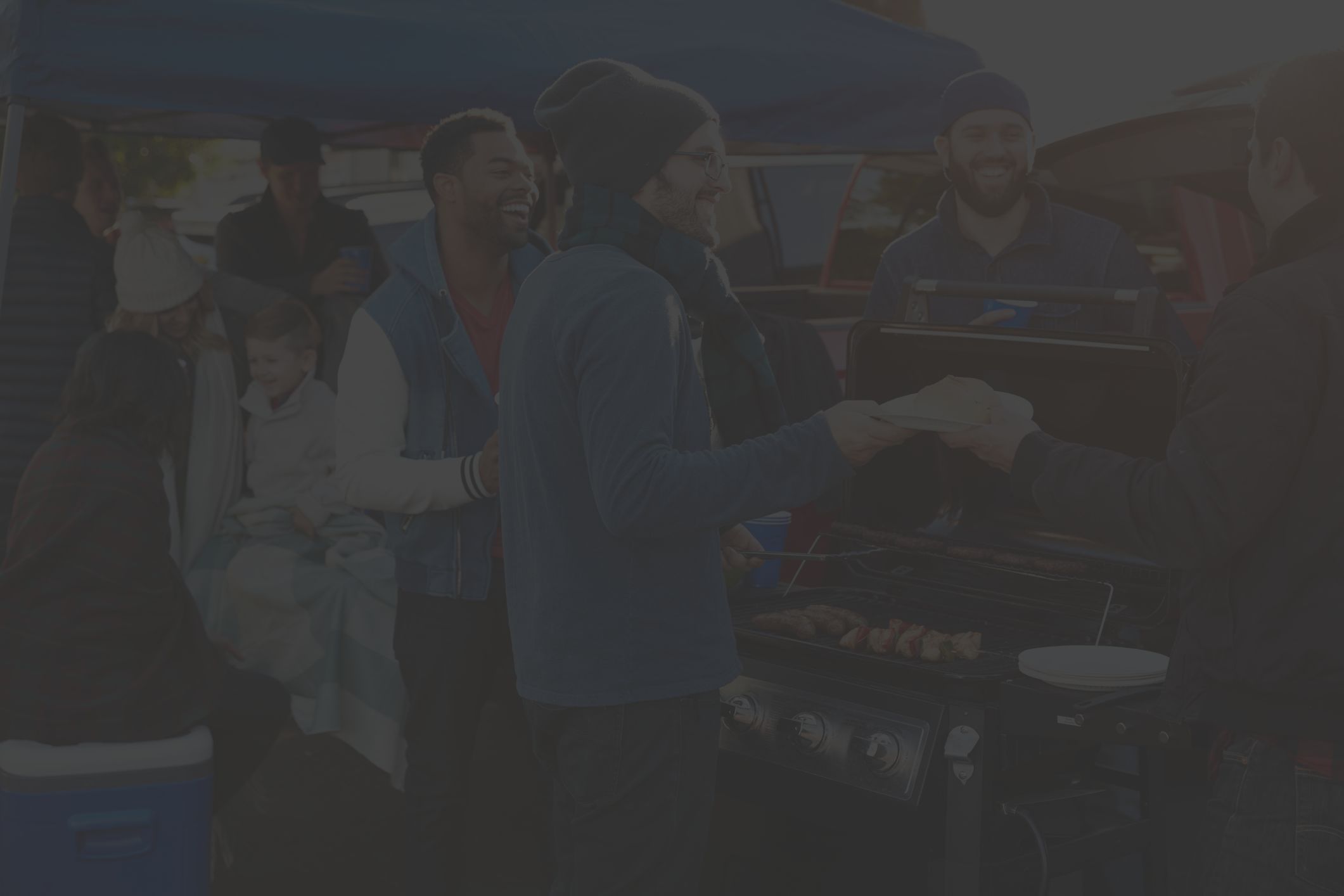 a group of friends enjoy each other's company at a football game tailgate party