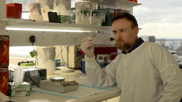 Dr Gil Stynes with the polymer device in the Barwon Health lab, Geelong. Picture: Paul Burston