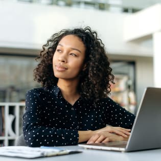 Woman pondering about online cookies at a computer